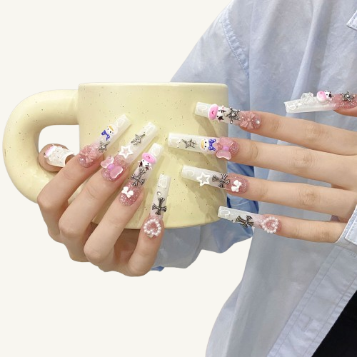A set of long square press-on nails, featuring various 3D bows, paired with a cute cow and pink glitter.