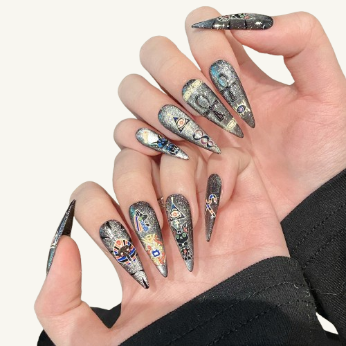 A set of long stiletto press-on nails with a silver glitter base, featuring hand-painted, colorful Ancient Egyptian symbols like the Ankh and a Pharaoh.