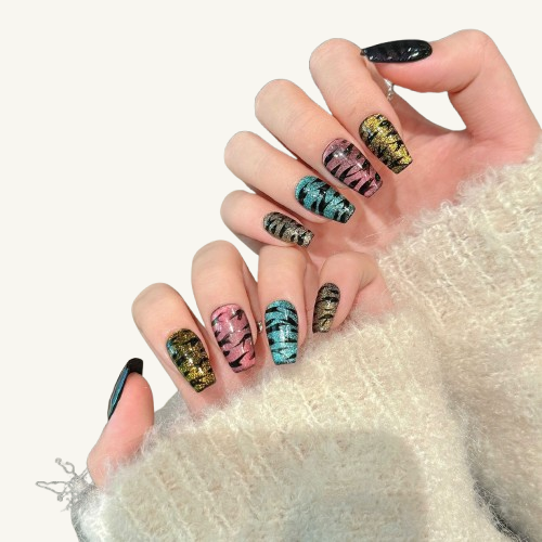 
A party-style handmade coffin press-on set featuring multi-colored cat-eye bases painted with black tiger stripes.
