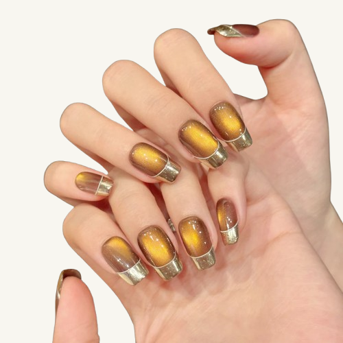 An autumn-themed handmade short square press-on set, amber cat-eye with matte gold French tips.