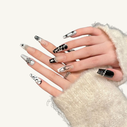 Hands wearing long coffin press-on nails in a black, white, and silver palette, featuring various designs like 3D metallic stars, crackle patterns, and abstract lines.