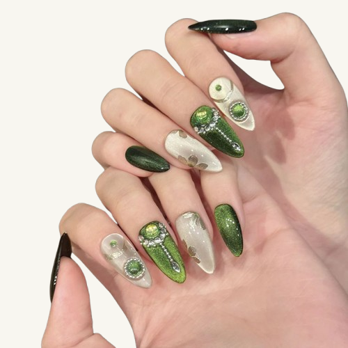 A set of elven forest themed long almond nails with green cat-eye, gold clovers, and a handmade green gem scepter.