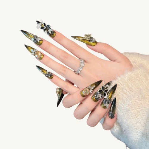 A heavily embellished luxury handmade stiletto press-on set, gold-to-black gradient cat-eye, covered with black roses, jewel butterflies, and chains.