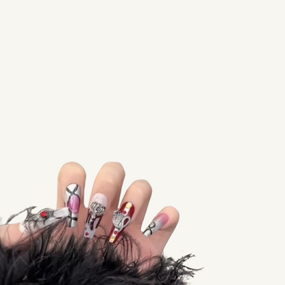 Hands wearing long, gothic-style press-on nails, with details including metallic chrome hearts, red blood drip patterns, and silver accents.