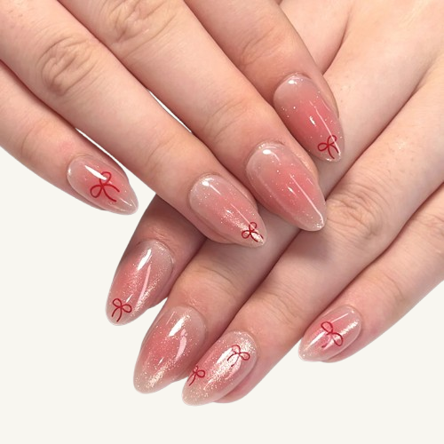  A set of Japanese kawaii style Stiletto press-on nails, featuring a blush shimmer effect and a hand-drawn style red knot design.