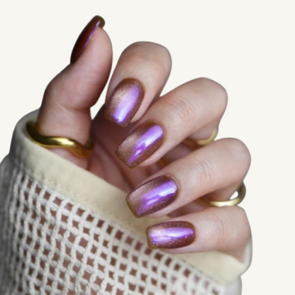 A magic elixir themed set of square press-on nails, bronze base with a purple chameleon cat-eye effect.
