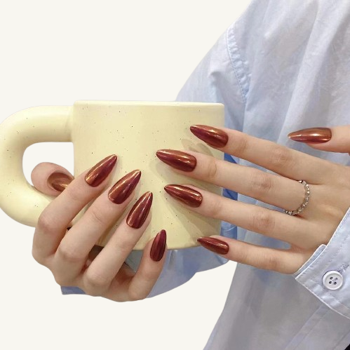 A set of solid color, minimalist style medium almond press-on nails with a silky, metallic russet sheen.