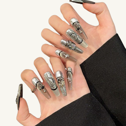  A set of handmade long coffin press-on nails, silver cat-eye and liquid metal texture, adorned with vintage metal charms like crosses, moons, and totems.
