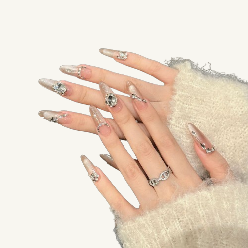 A set of gentle style long coffin press-on nails with a nude cat-eye base, featuring a luxury rhinestone chain and jewelry design.