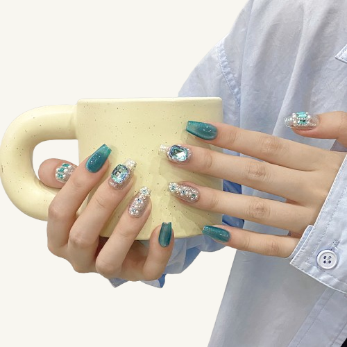 Discover the "Ocean Heart" luxury press-on nails, a perfect blend of teal cat-eye and ice gemstone designs. Handmade with pearls and rhinestones, reusable. Get your legendary nails today.