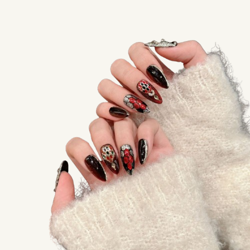 A set of jewelry-style stiletto press-on nails with a red and black snakeskin design, adorned with a 3D serpent head and a cat-eye effect.