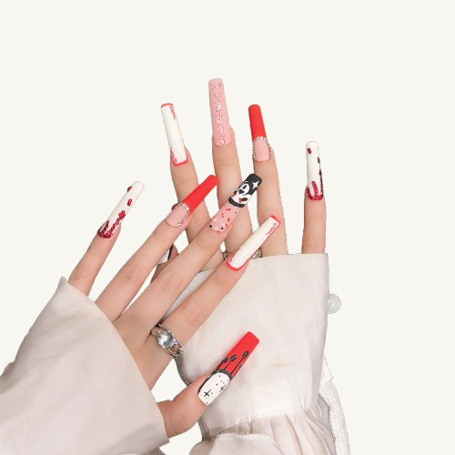 Hands wearing extra-long Halloween press-ons with a ghost face, red rhinestone drips, and unique red undersides.