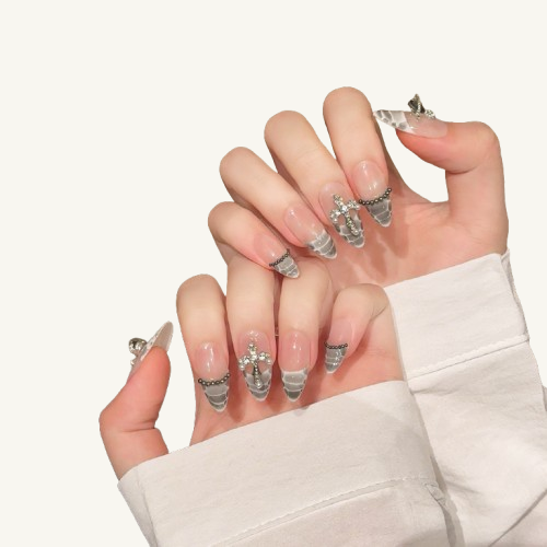 A set of cool-toned snake-themed long almond nails, with grey snakeskin French tips, a handmade cross, and black beads.