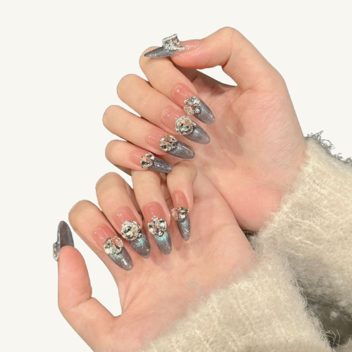 A set of handmade oval press-on nails, grey-green cat-eye gradient, inlaid with large, clear crystals in various cuts.Starry_Night_Press-