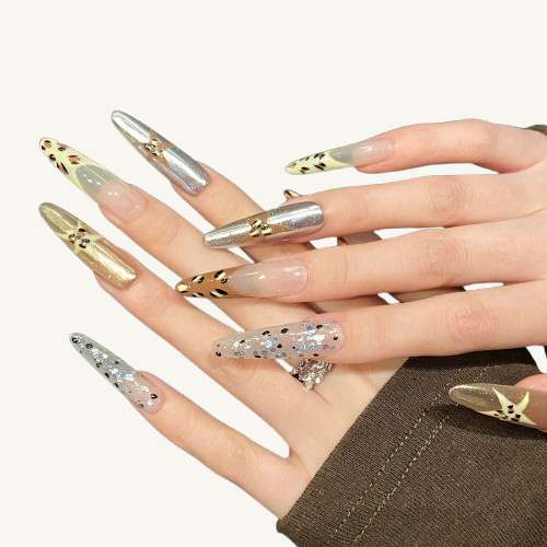 A fashion jigsaw style handmade stiletto press-on set, piecing together various elements like leopard print, a star, gold, silver, and glitter.