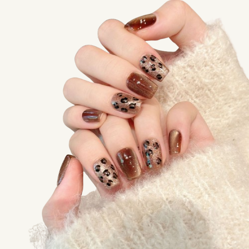 A sexy style set of handmade coffin press-on nails with a brown glitter cat-eye base, adorned with a classic leopard print.